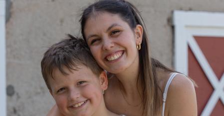 Program Requirements au pair hugging host kid